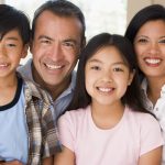 family smiling while in the living room