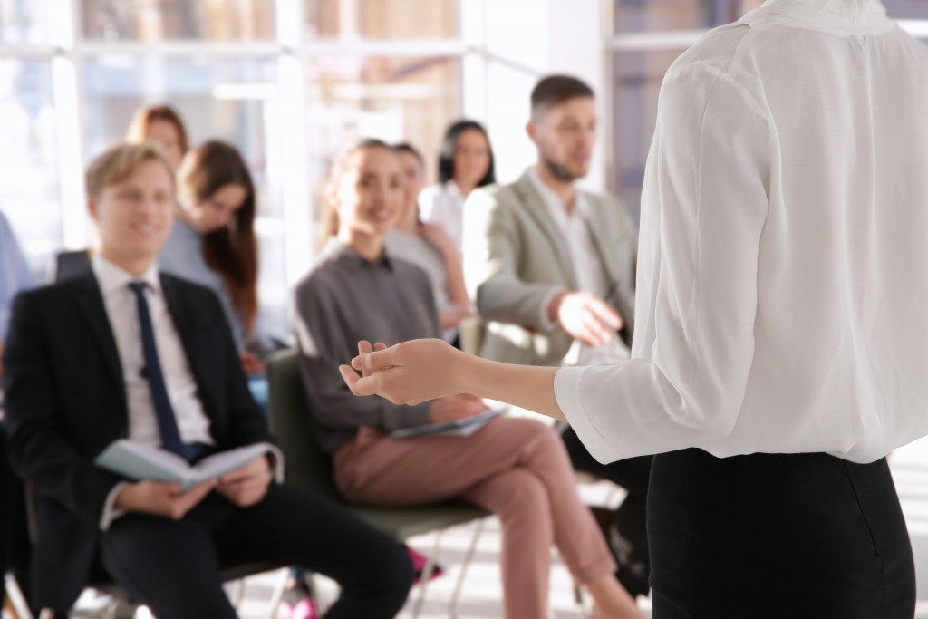 A woman leading a training of employees in office