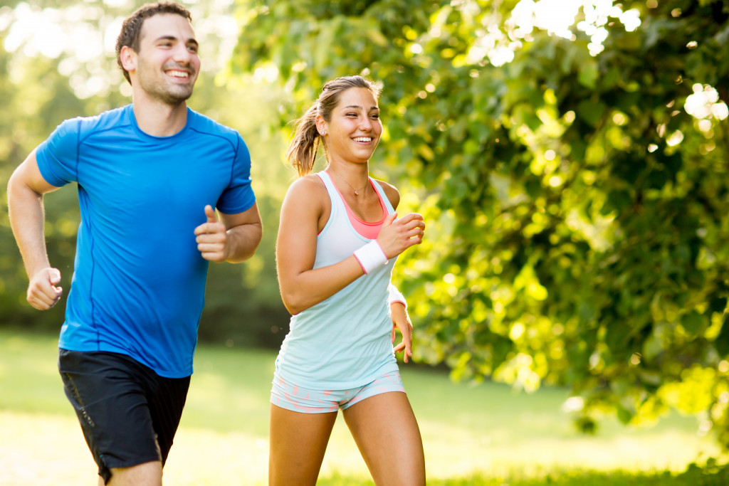 A couple jogging together in a park