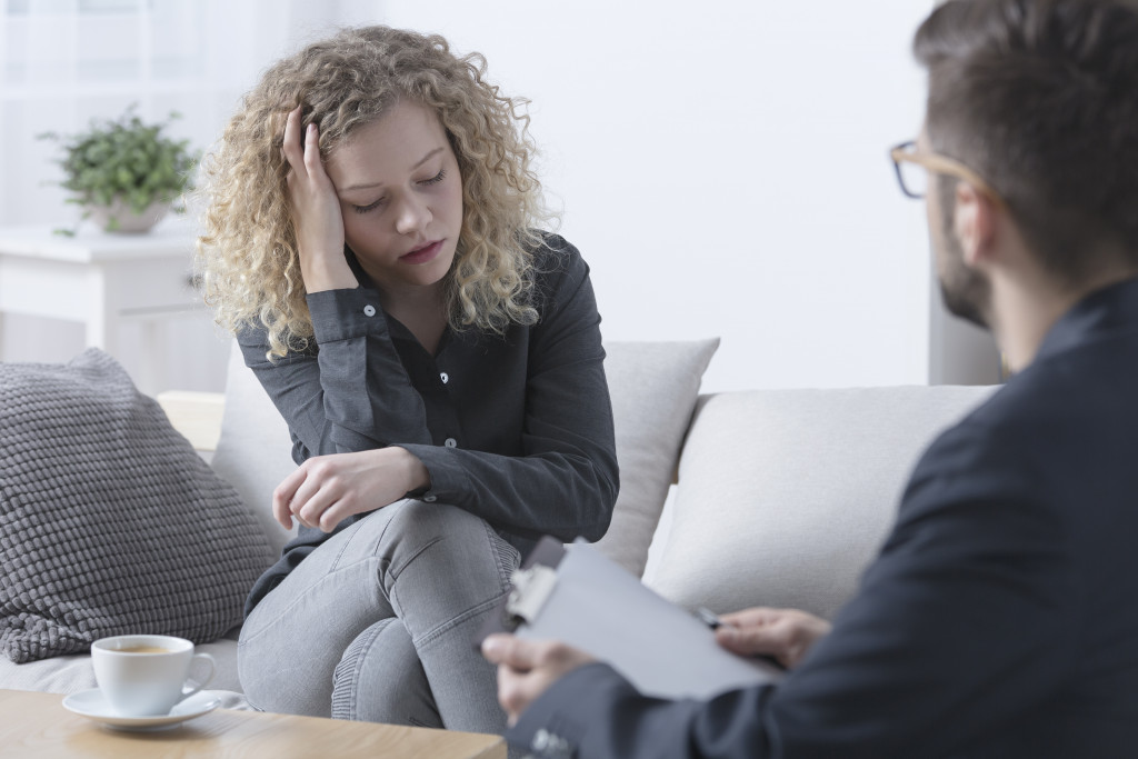 A woman talking to a therapist in an office