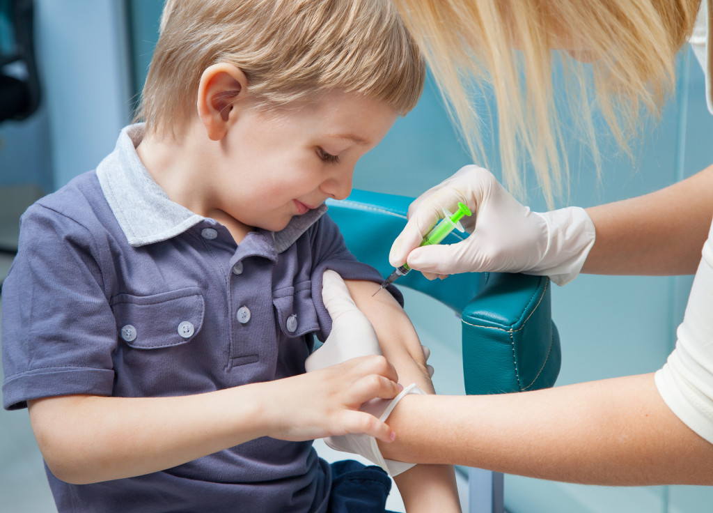 A kid receiving his vaccination injection