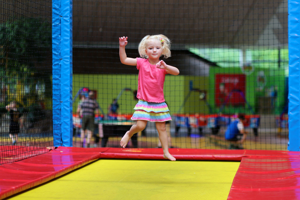 A child playing at a trampoline