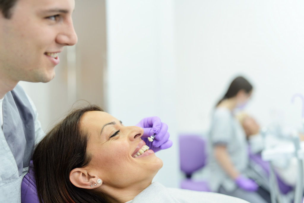 a female patient and a dentist looking at dental implant