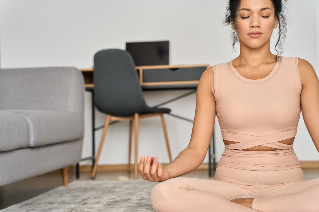 A woman doing yoga, taking a break from working