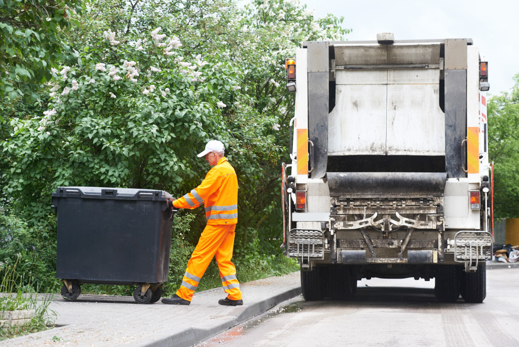 garbage collector truck loading waste