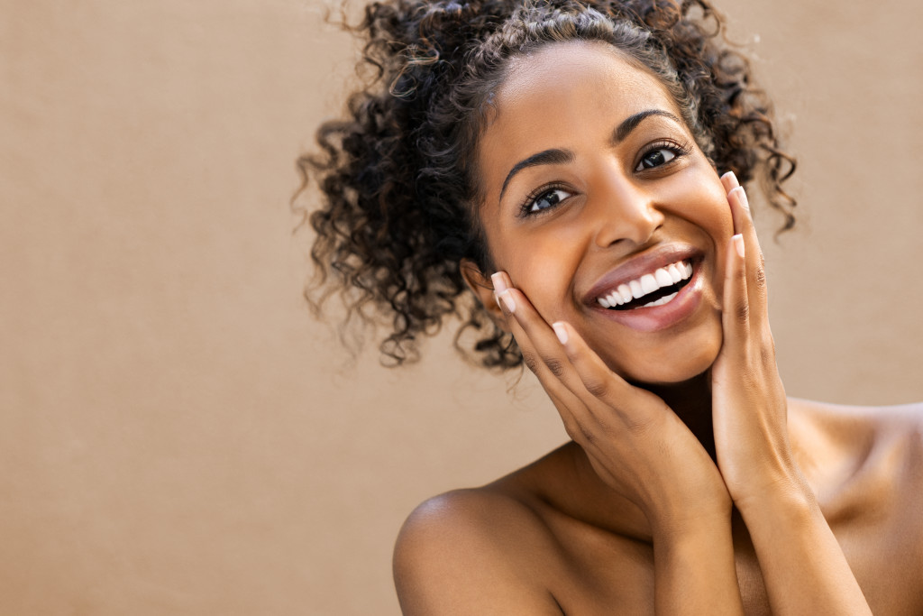 Beautiful young woman smiling after fantastic face treatment.