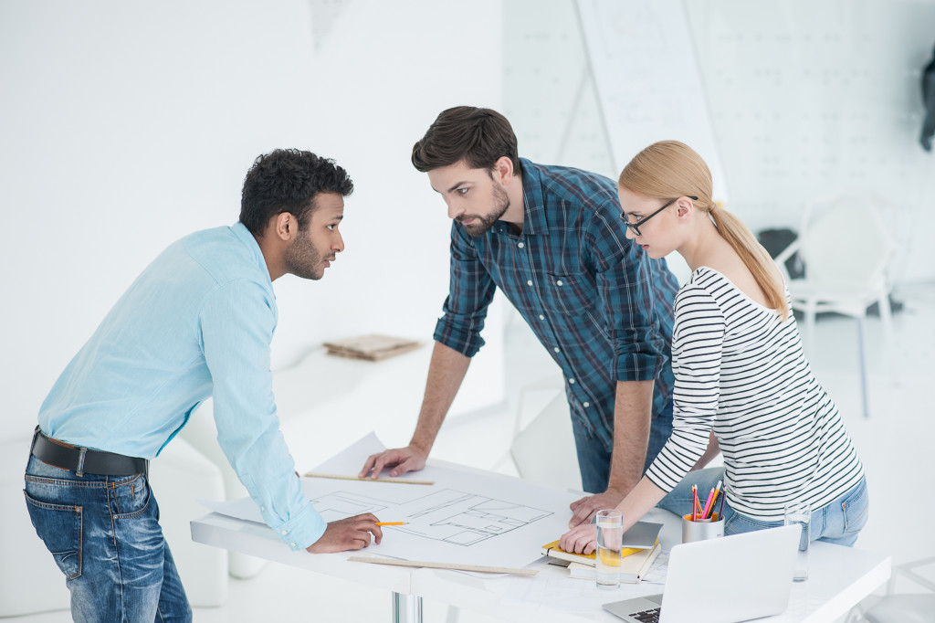 Business executives networking and collaborating with each other at an office.