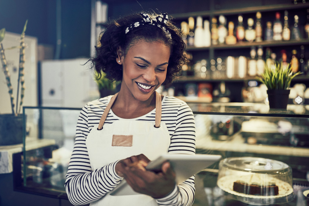 Business owner using a tablet to manage her business.