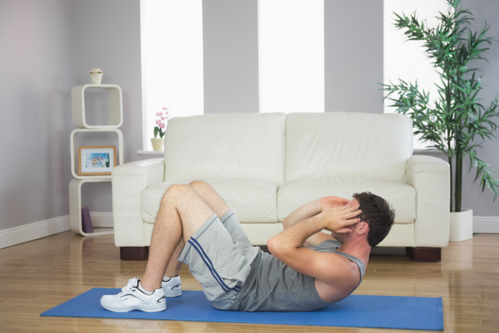 man on the floor doing situps